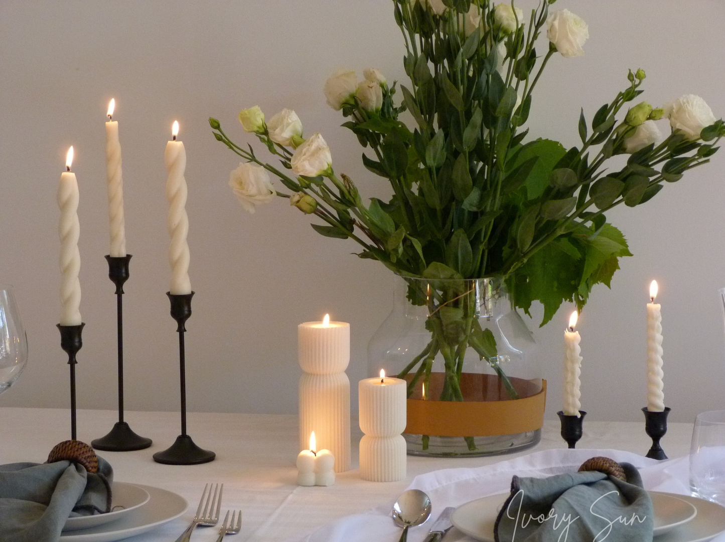 Dining table setting with candles, flowers, and cutlery on a neutral background.
metal candle holders, black candle holders, black candle holders, candle holders australia, candle holder, candle holder australia, ivory sun candle holder, candle accessories, wedding candle holders, dinner party candle holders, decor candle holders, twin candle holders, table decor, taper candles, candle holders set