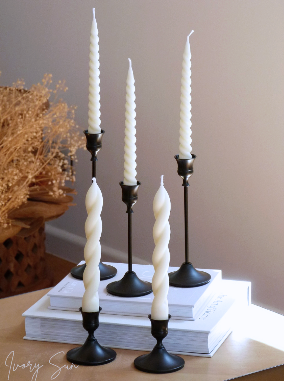 White twisted taper candles on black candlesticks with a neutral background.
metal candle holders, black candle holders, black candle holders, candle holders australia, candle holder, candle holder australia, ivory sun candle holder, candle accessories, wedding candle holders, dinner party candle holders, decor candle holders, twin candle holders, table decor, taper candles, candle holders set