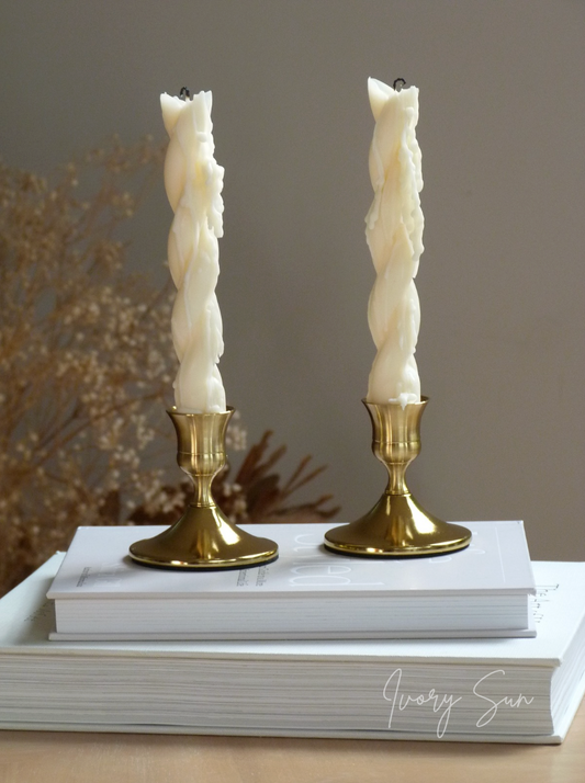 Two white twisted taper candles on gold candle holders with a blurred background.
metal candle holders, gold candle holders, golden candle holders, candle holders australia, candle holder, candle holder australia, ivory sun candle holder, candle accessories, wedding candle holders, dinner party candle holders, decor candle holders, twin candle holders, table decor, taper candles