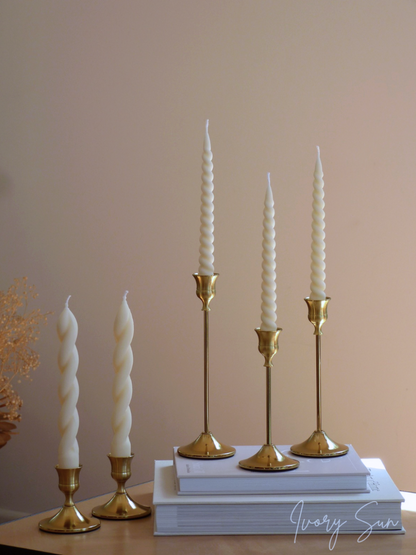 Set of white candles in gold candle holders on a neutral background.
metal candle holders, gold candle holders, golden candle holders, candle holders australia, candle holder, candle holder australia, ivory sun candle holder, candle accessories, wedding candle holders, dinner party candle holders, decor candle holders, twin candle holders, table decor, taper candles