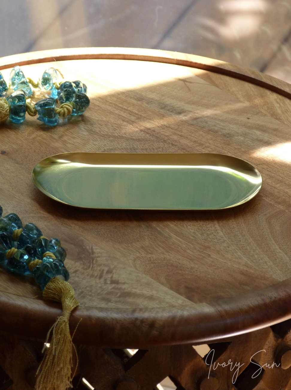 Gold oval tray on a wooden surface.
metal candle tray, gold candle tray, golden candle tray, golden candle plate, oval candle tray, candle tray australia, candle holder, candle holder australia, ivory sun candle holder, candle accessories