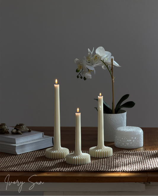 Three cream-colored ribbed candlesticks with lit flame-shaped candles.
Lumi Candle, sculptural candle, pilar candle, soy candle, scented soy candle, essential oils candle, beeswax candle, non toxic candles, decor candles, Sculptural candles Australia
Decorative candles Australia
Beeswax candles Australia
Handcrafted soy candles
Modern candles Australia
Book candles Australia
Gift ideas for home lovers 
Housewarming gifts Australia
Sculptural Candles
Candles
Candles Australia